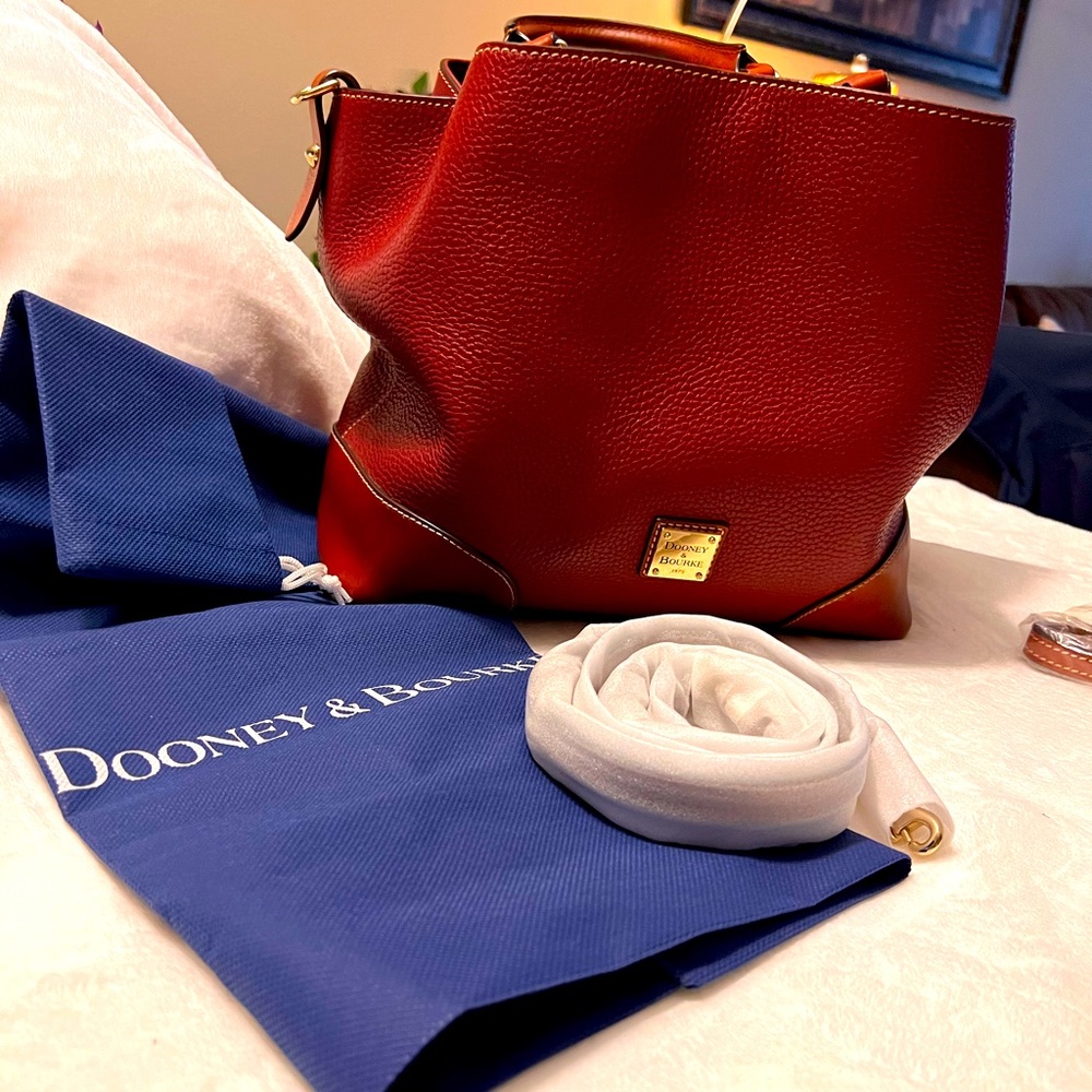 Dooney bag is very large inside can hold things in each 3 separate compartments